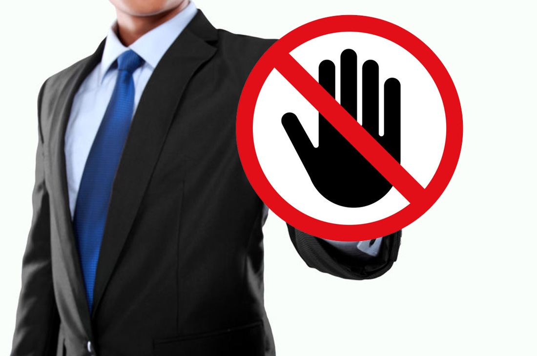 Businessman with 'do not touch' sign